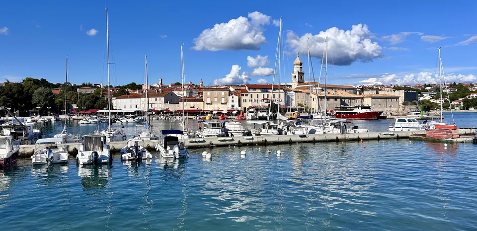 Krk town’s harbour, boats and cathedral bell tower