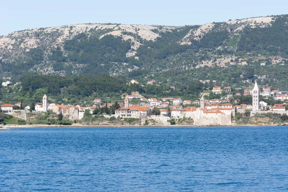 Rab’s historic waterfront and four bell towers seen from the sea
