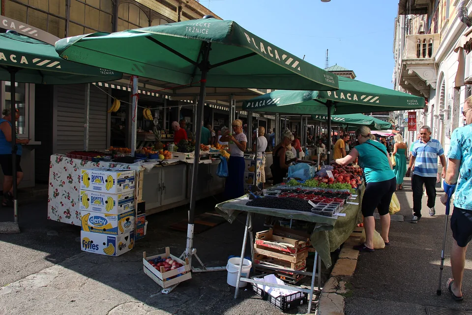 Fruit stalls and shoppers at Rijeka City Market