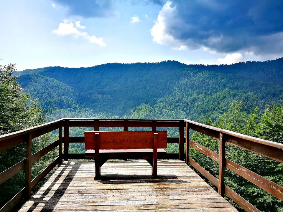 A wooden viewing platform above forested hills at Razloge in Risnjak National Park