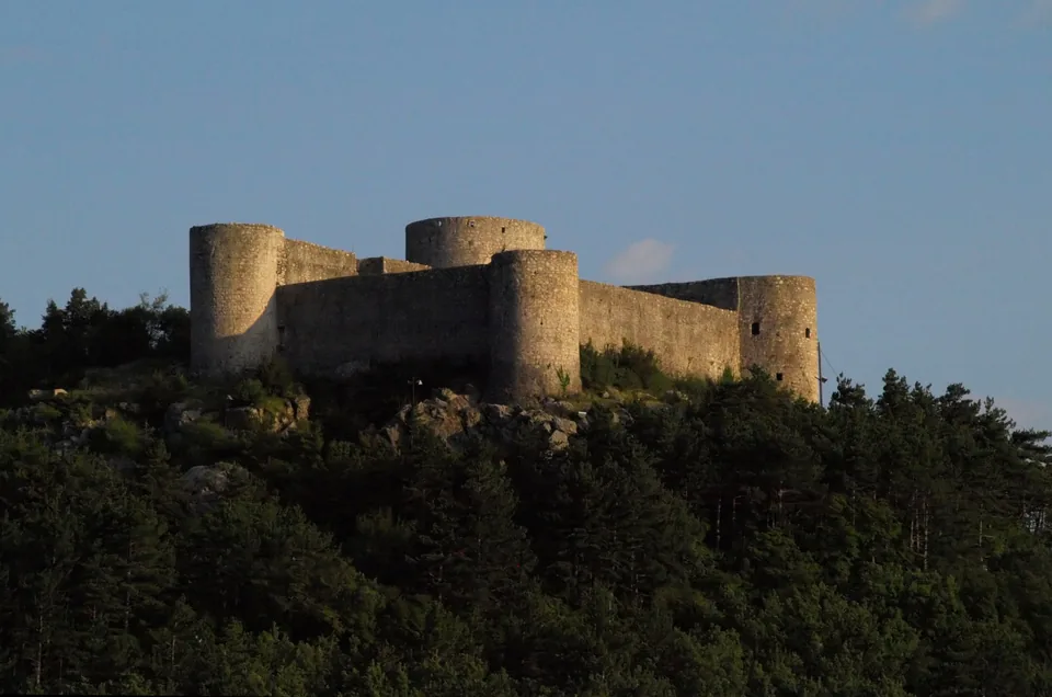 Drivenik Castle rising above trees in Vinodol